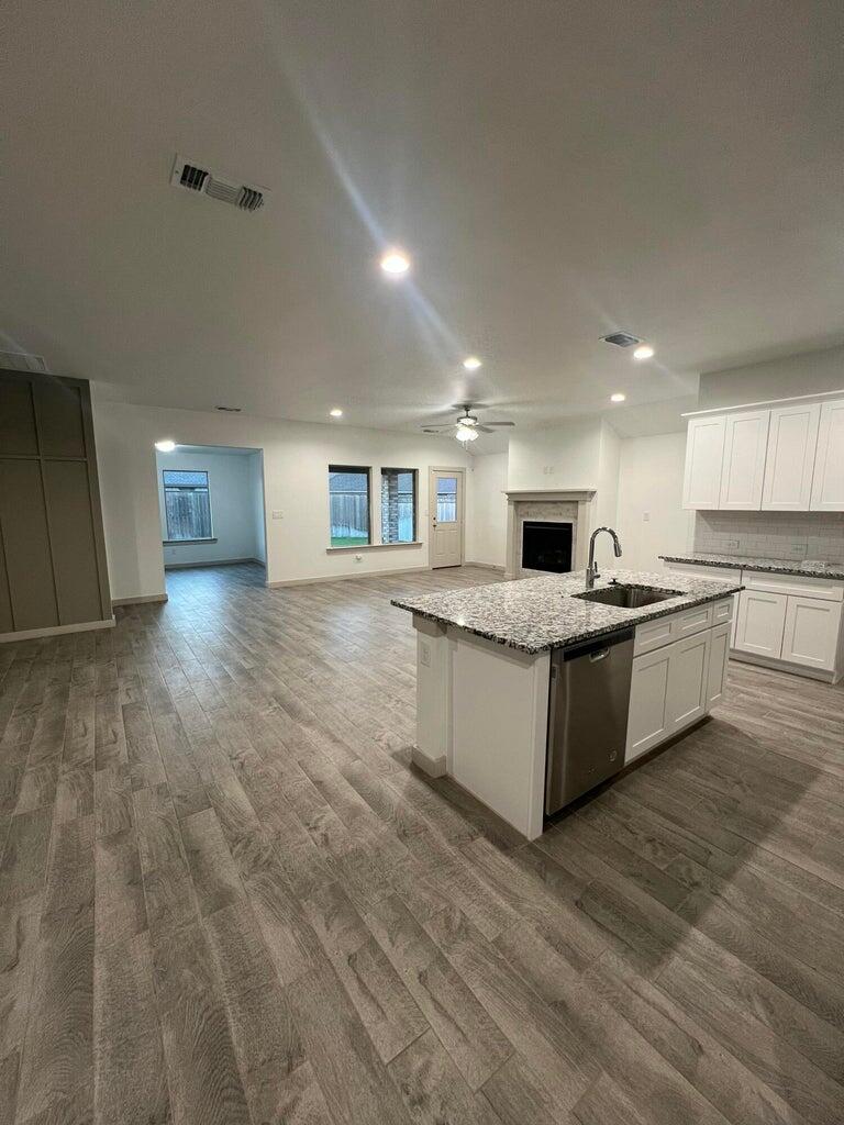 10518 Aberdeen Avenue Lubbock, TX 79424 - Photo 3 of 20 a large kitchen with a large counter top stainless steel appliances and cabinets