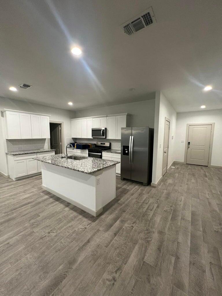 10518 Aberdeen Avenue Lubbock, TX 79424 - Photo 5 of 20 a large kitchen with cabinets and stainless steel appliances