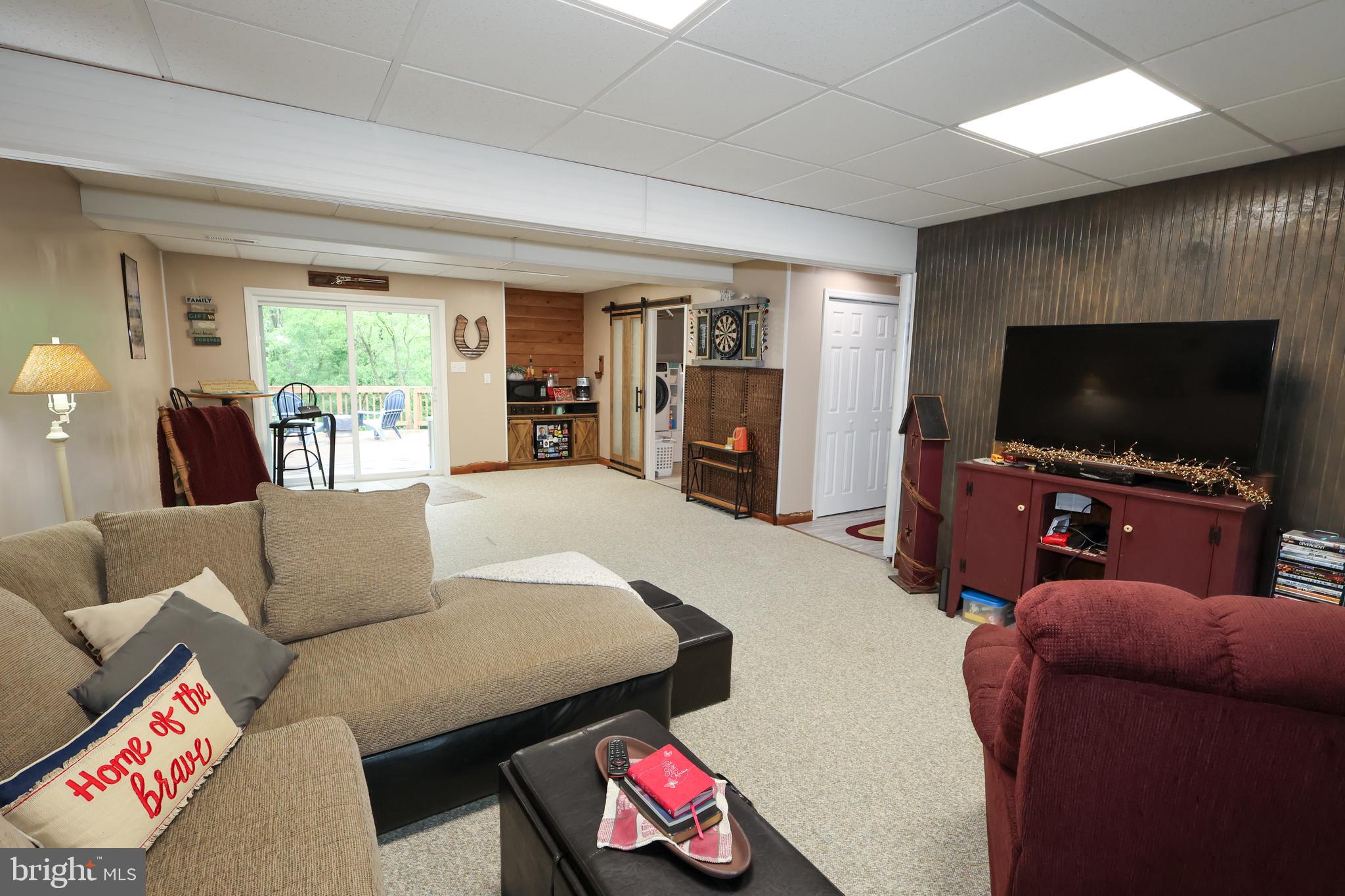 16919 Shaffer Road Sharpsburg, MD 21782 - Photo 33 of 58 a living room with furniture and a flat screen tv