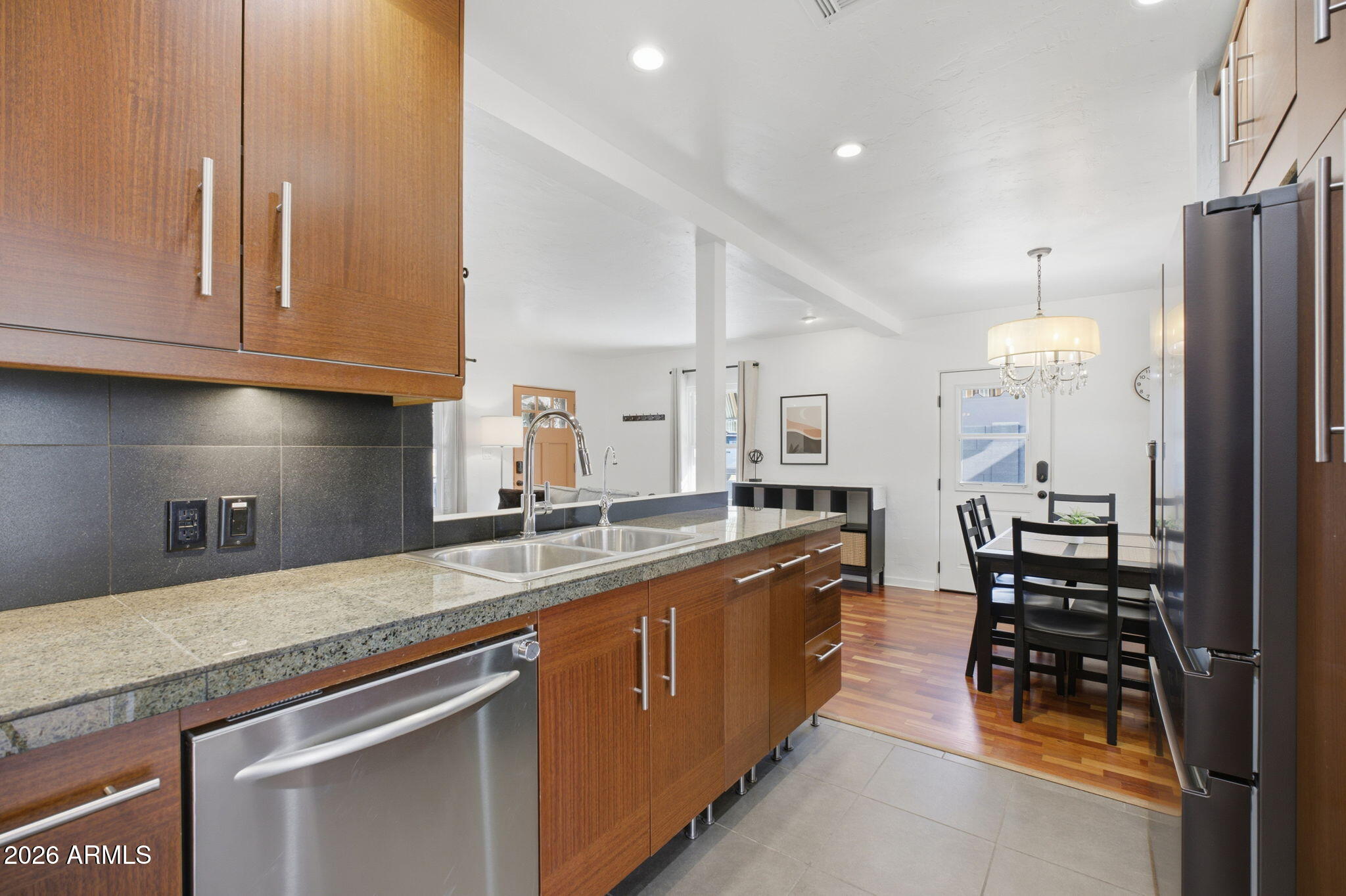 427 East Oregon Avenue Phoenix, AZ 85012 - Photo 11 of 32 a kitchen with stainless steel appliances granite countertop a sink a stove and a refrigerator