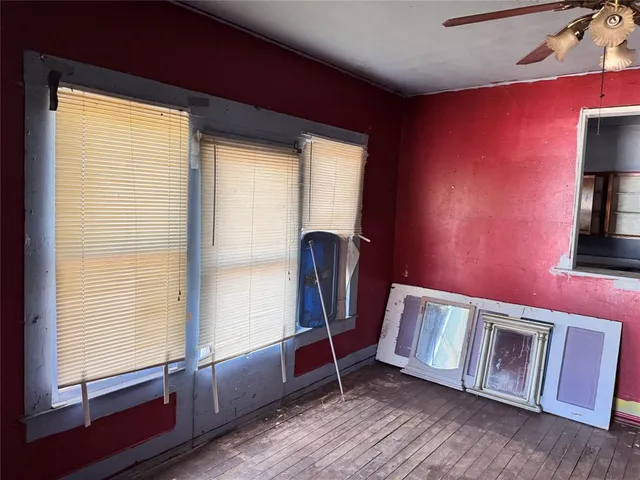 a view of workspace with window and wooden floor