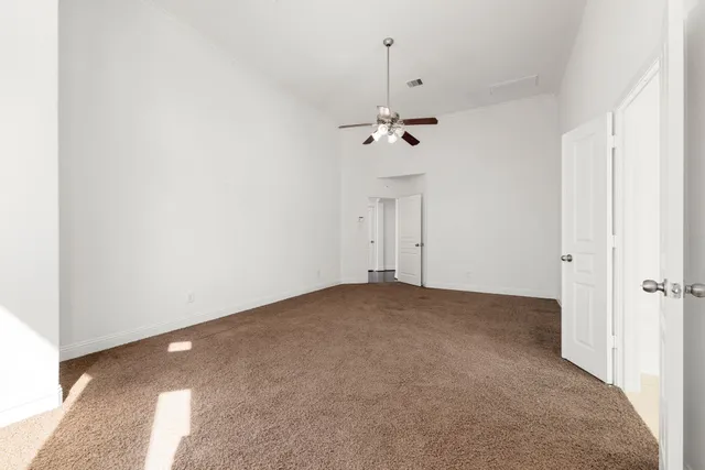 a view of empty room with a fan