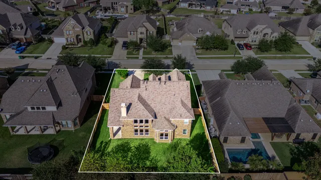 an aerial view of a house with garden space and street view