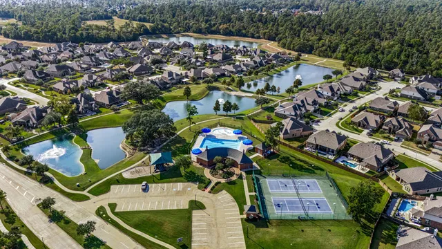 an aerial view of a house with a swimming pool outdoor seating