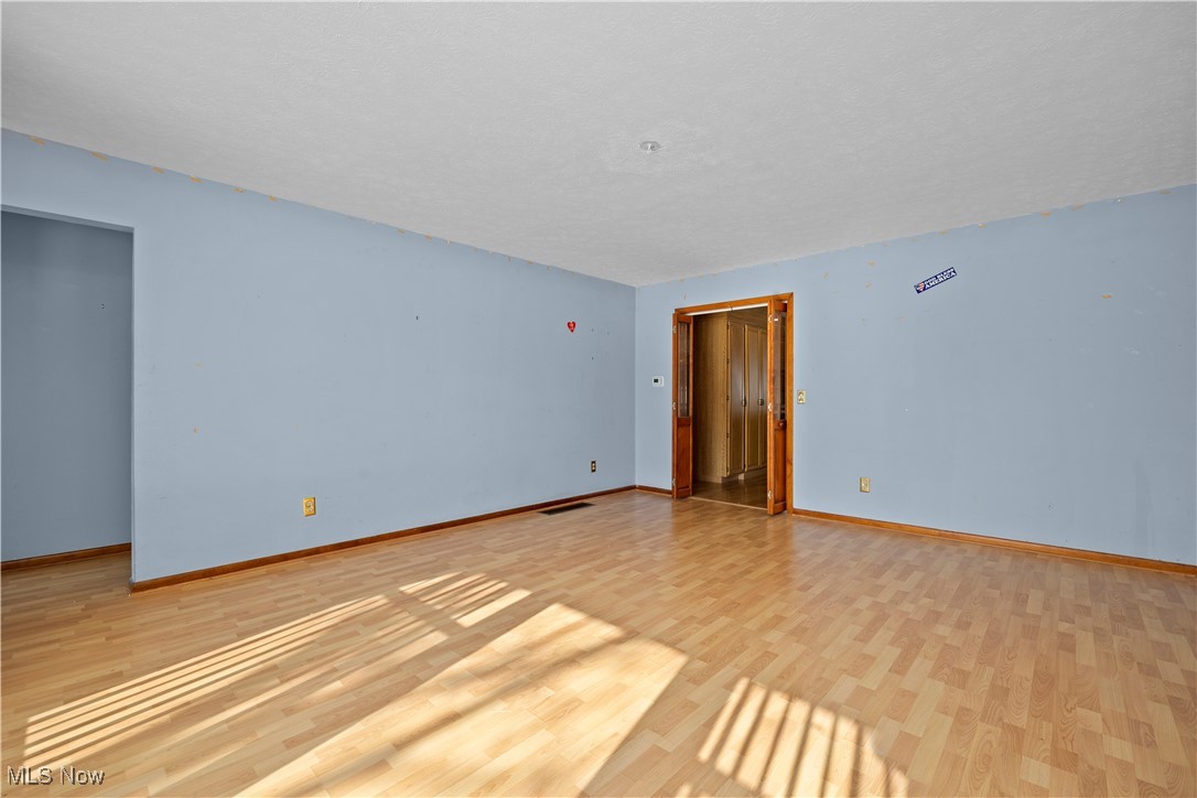 14015 West Lake Road Vermilion, OH 44089 - Photo 13 of 50 Unfurnished room featuring light wood finished floors and baseboards