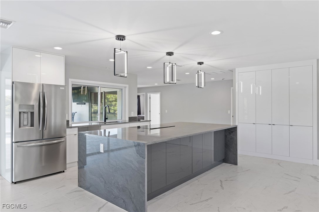 432 Seaworthy Road North Fort Myers, FL 33903 - Photo 13 of 28 a kitchen with kitchen island a counter top space stainless steel appliances and cabinets