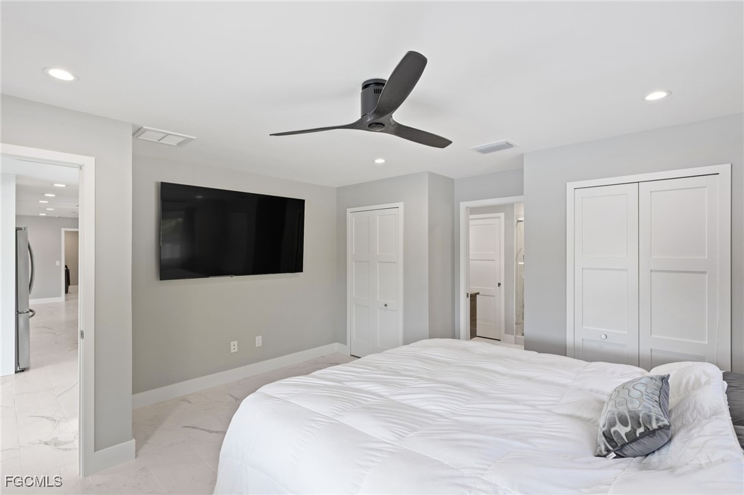 432 Seaworthy Road North Fort Myers, FL 33903 - Photo 14 of 28 a bedroom with a bed and a flat screen tv