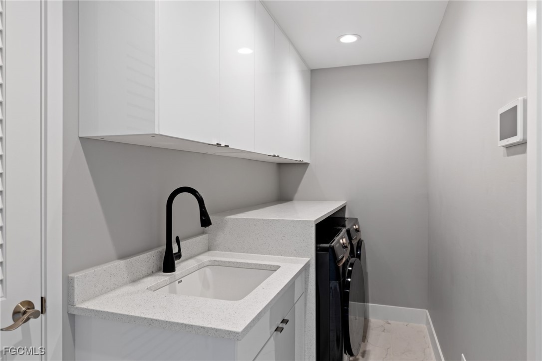 432 Seaworthy Road North Fort Myers, FL 33903 - Photo 21 of 28 a close view of a sink and washing machine in a bathroom