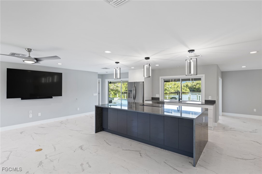 432 Seaworthy Road North Fort Myers, FL 33903 - Photo 9 of 28 a kitchen with kitchen island a sink stainless steel appliances and cabinets