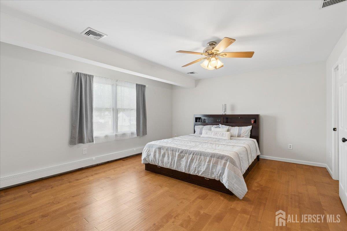 45 Walnut Street Edison, NJ 08817 - Photo 14 of 28 a bedroom with a bed chandelier and a window