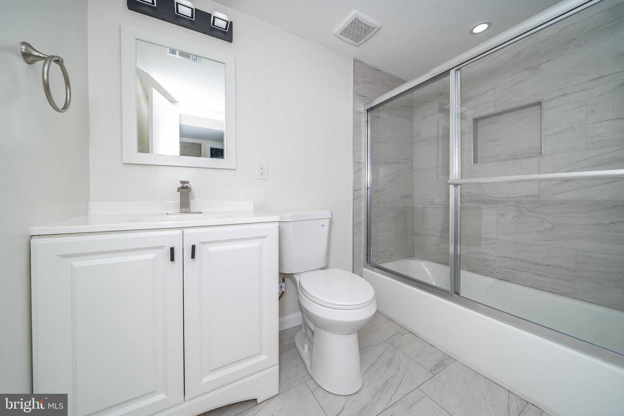 9910 Walker House Road, Unit 99104 Gaithersburg, MD 20886 - Photo 30 of 32 a bathroom with a sink toilet and shower