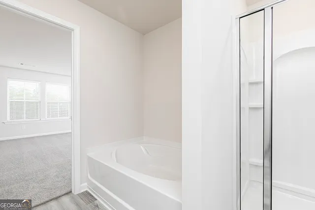 a white bath tub sitting next to a window