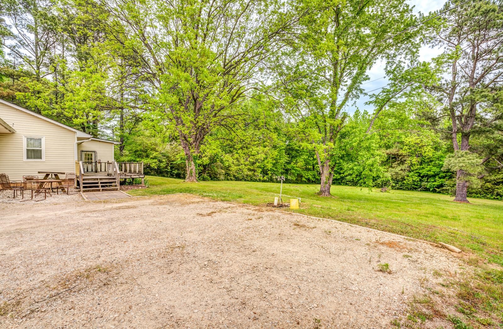 6125 Warren Road Oakland, TN 38060 - Photo 38 of 40 Spacious gravel driveway with a level grassy area and mature trees