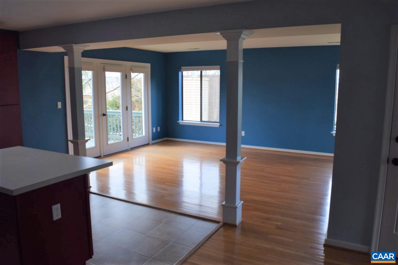 1292 Millpond Road Charlottesville, VA 22902 - Photo 3 of 42 a view of an empty room with wooden floor and a window
