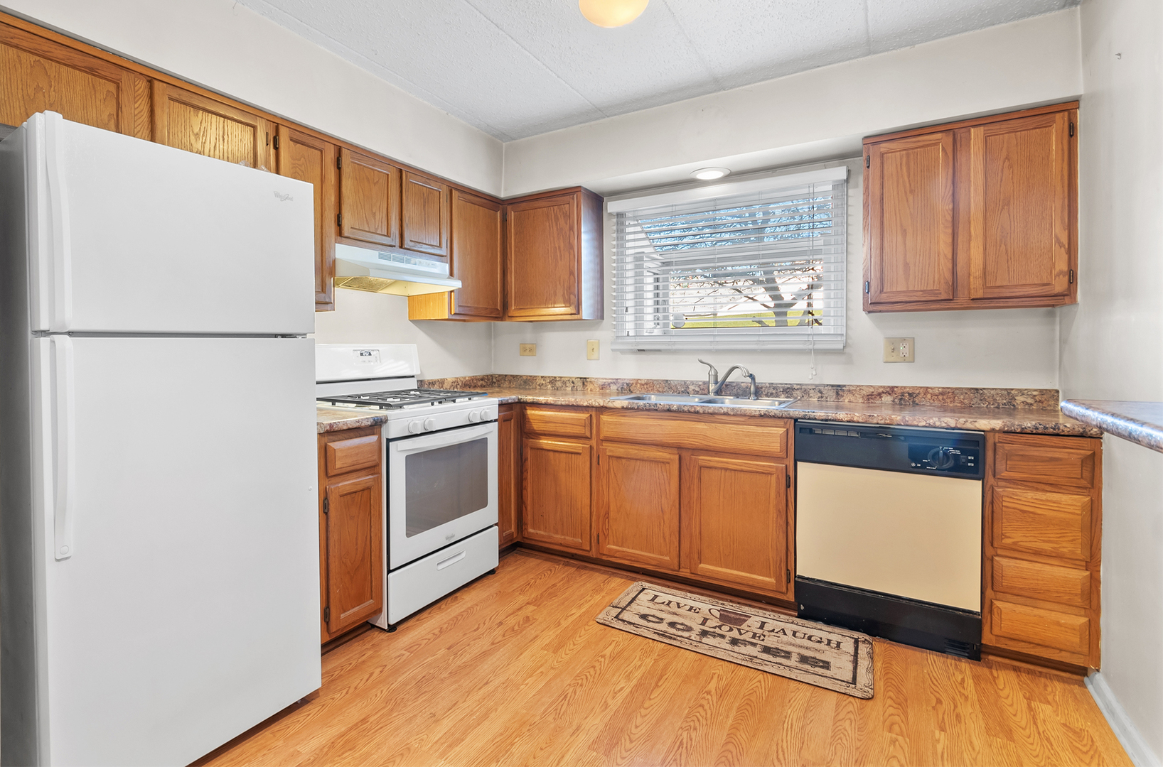 18302 Robin Lane, Unit D1 Homewood, IL 60430 - Photo 8 of 22 a kitchen with granite countertop a refrigerator a sink and white cabinets