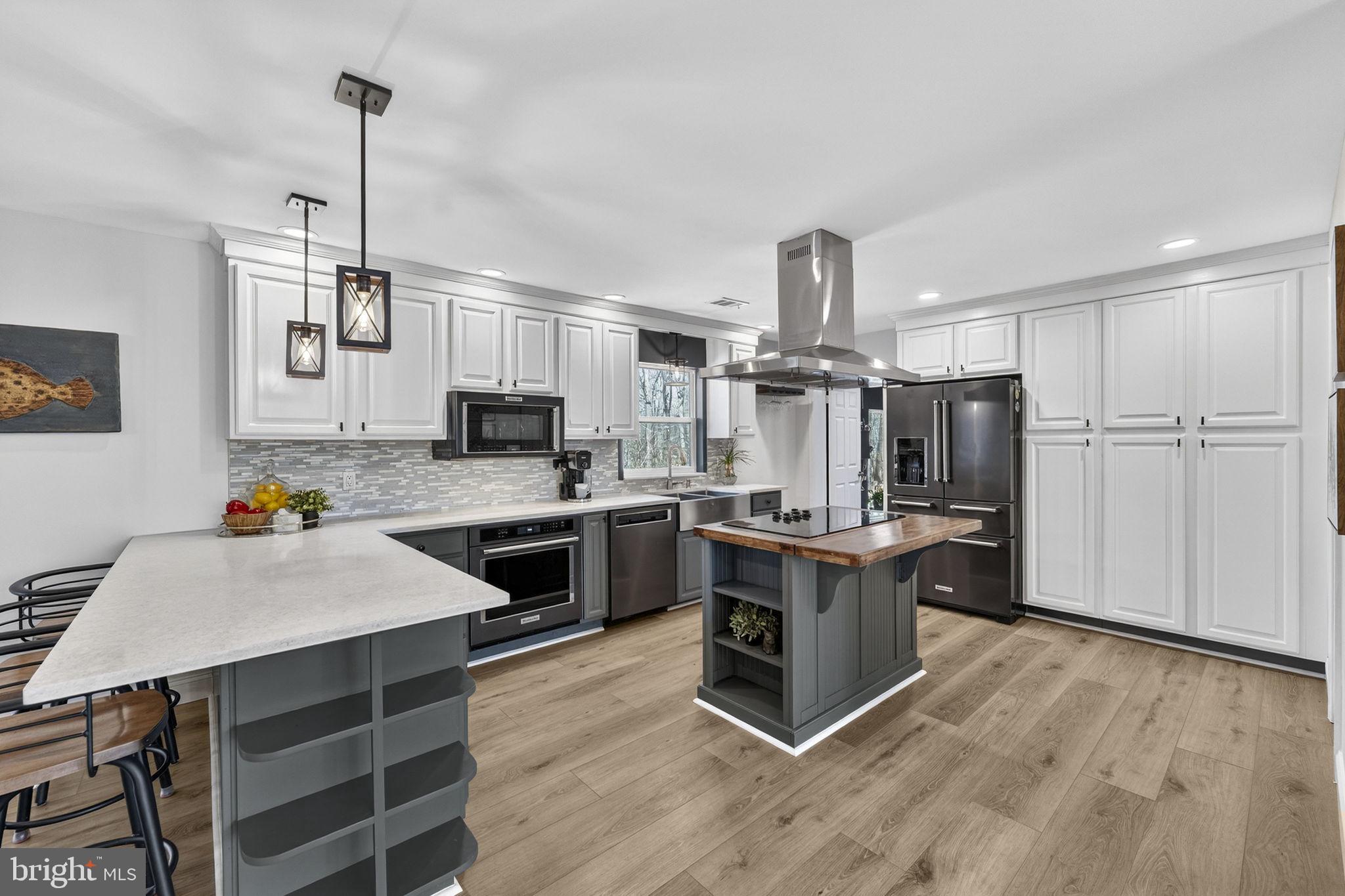 7427 Maple Branch Road Clifton, VA 20124 - Photo 22 of 100 Kitchen with Quartz Countertop & Barstool Overhang