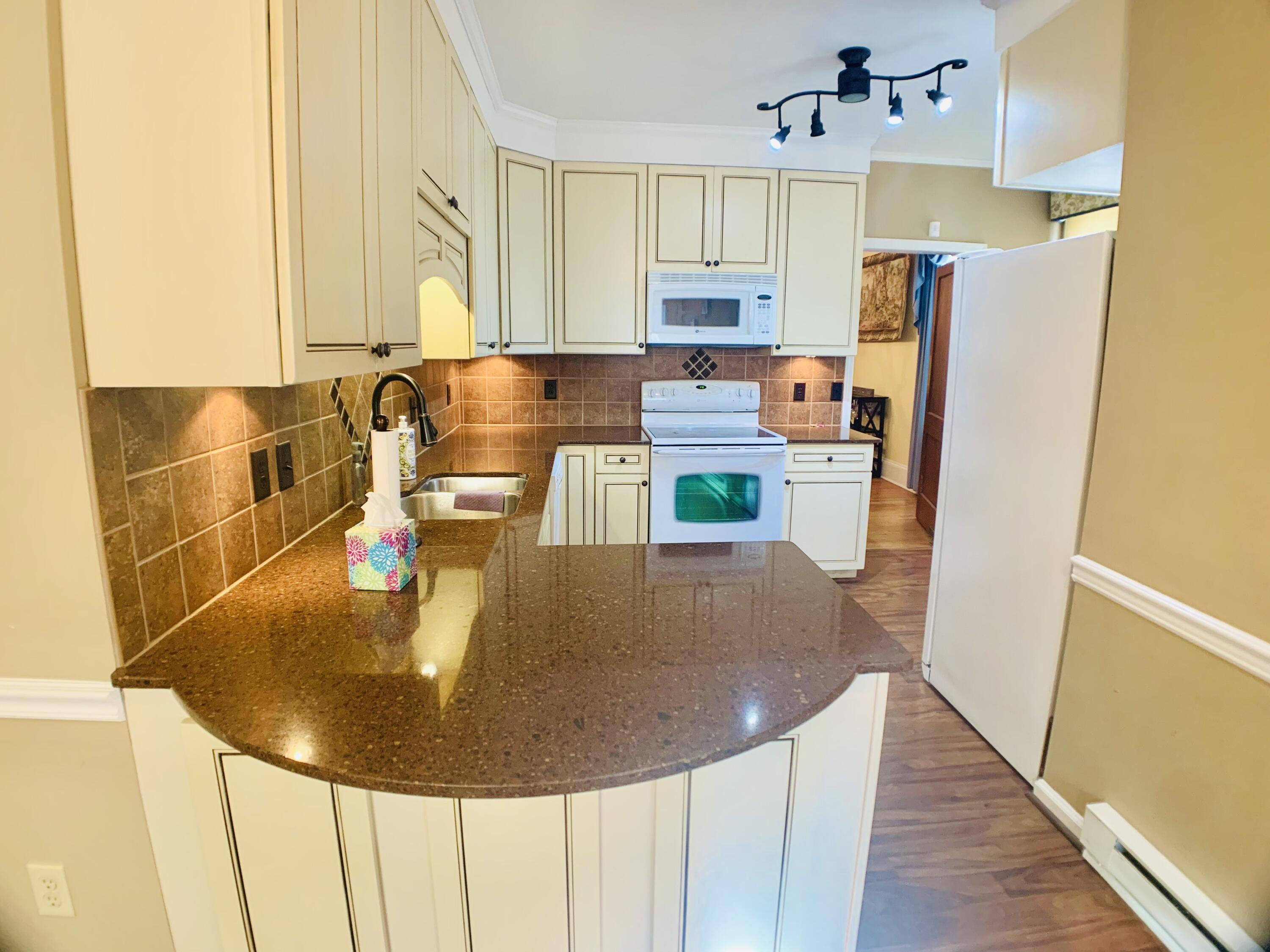 709 McCormick Boulevard Clifton Forge, VA 24422 - Photo 24 of 74 a kitchen with refrigerator and white countertops