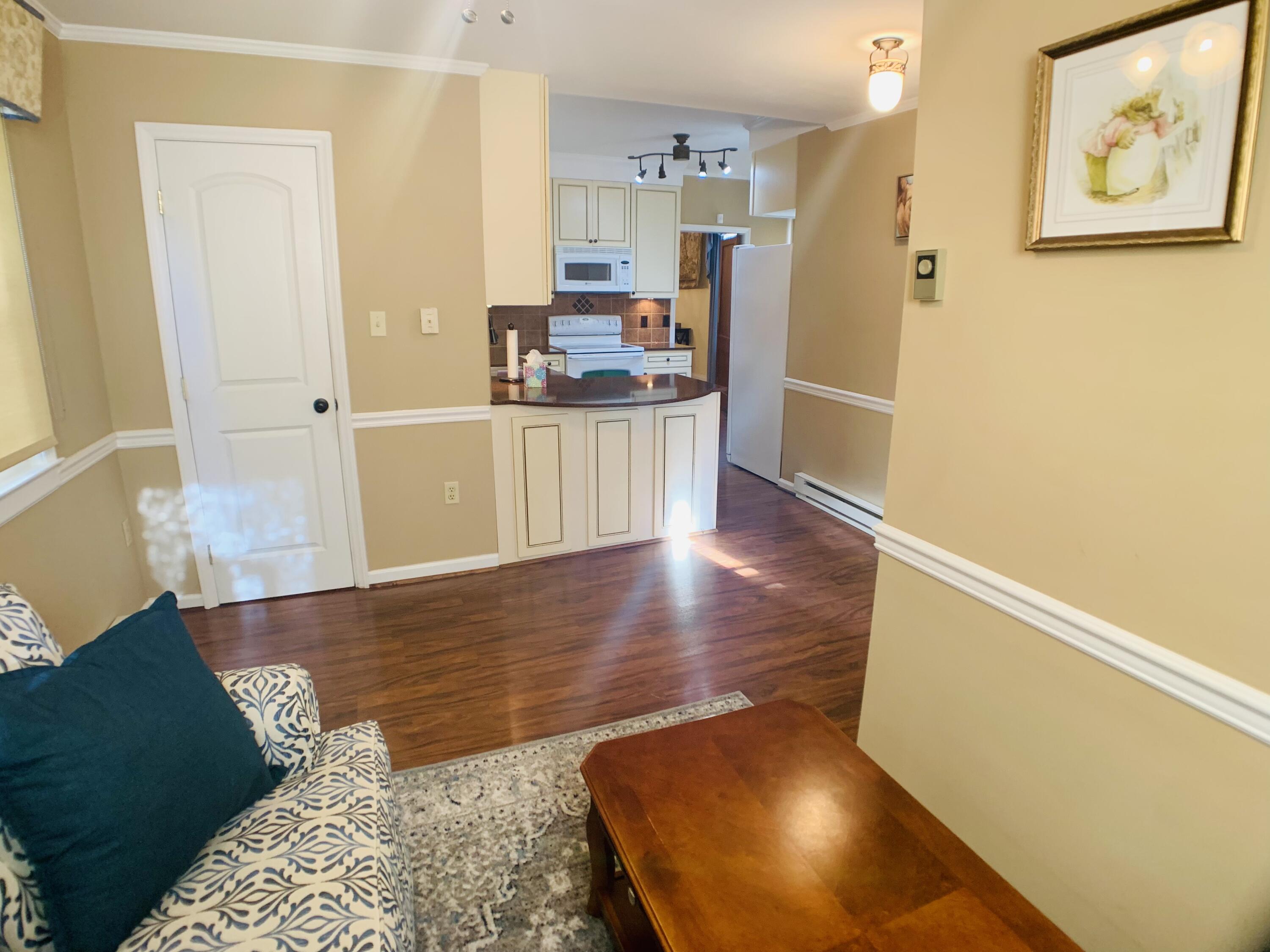 709 McCormick Boulevard Clifton Forge, VA 24422 - Photo 29 of 74 a kitchen with stainless steel appliances granite countertop a refrigerator a stove and a wooden floors