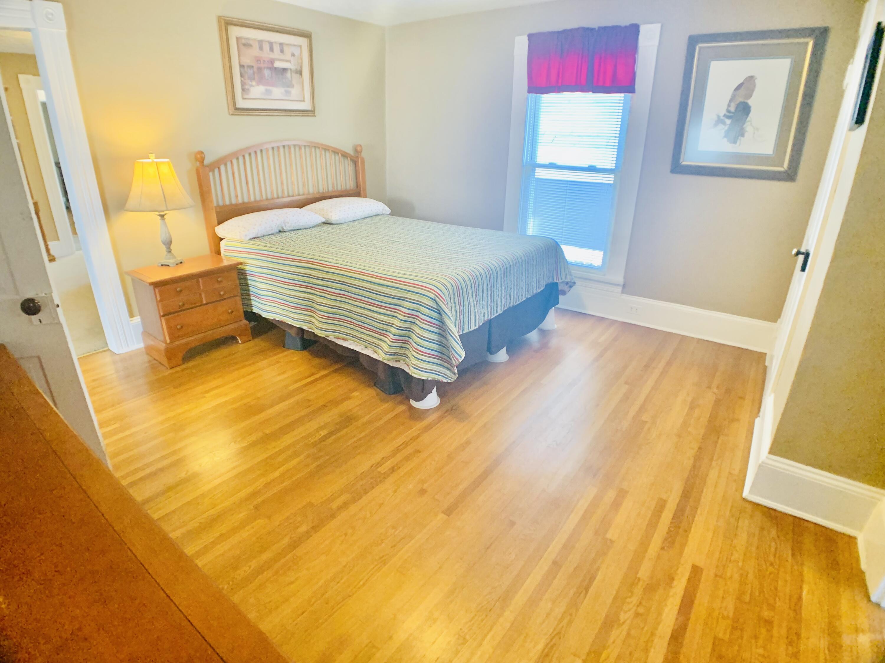 709 McCormick Boulevard Clifton Forge, VA 24422 - Photo 41 of 74 a bedroom with a bed and wooden floor