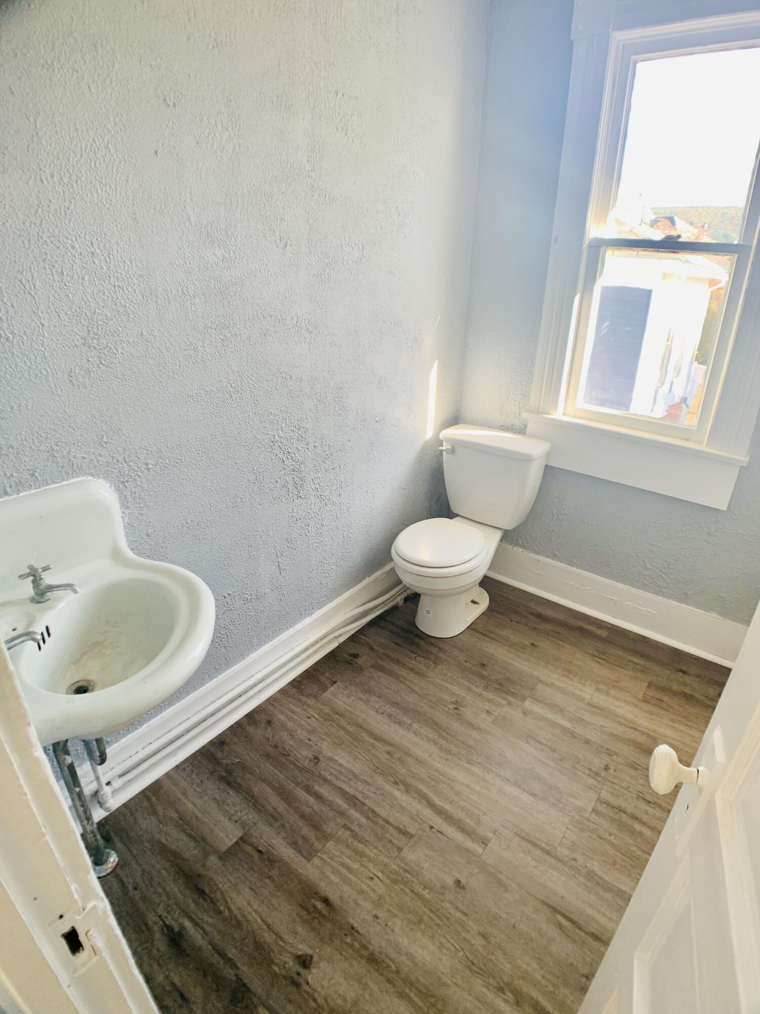 709 McCormick Boulevard Clifton Forge, VA 24422 - Photo 74 of 74 a bathroom with a granite countertop sink and a toilet