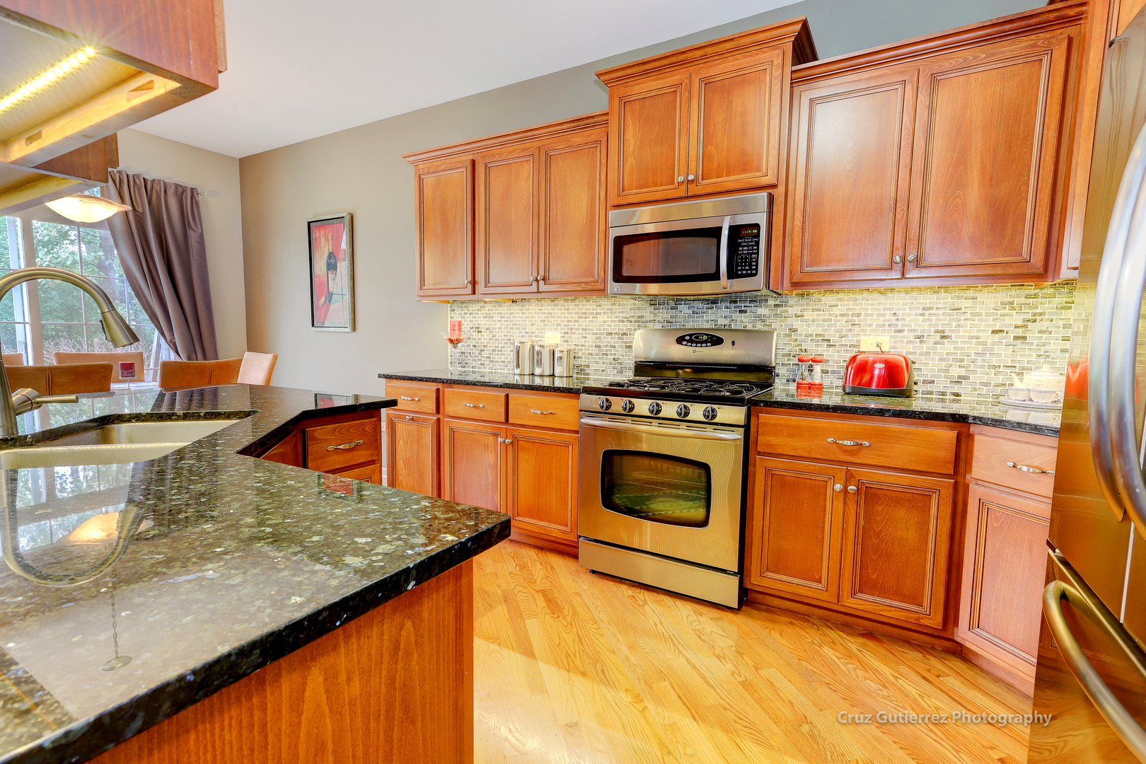450 North River Road Naperville, IL 60540 - Photo 8 of 26 a kitchen with stainless steel appliances granite countertop a sink stove and microwave