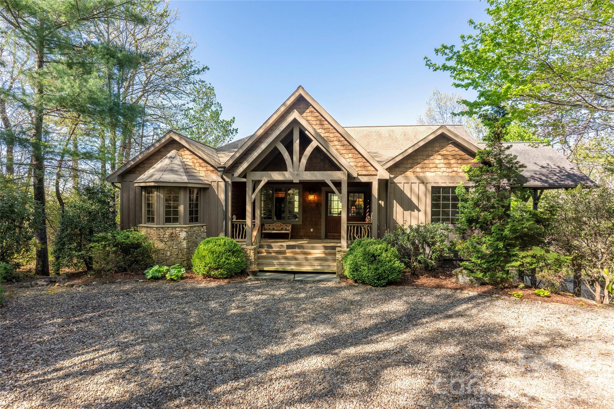 601 Hawk Mountain Road Lake Toxaway, NC 28747 - Photo 1 of 48 a front view of a house with garden