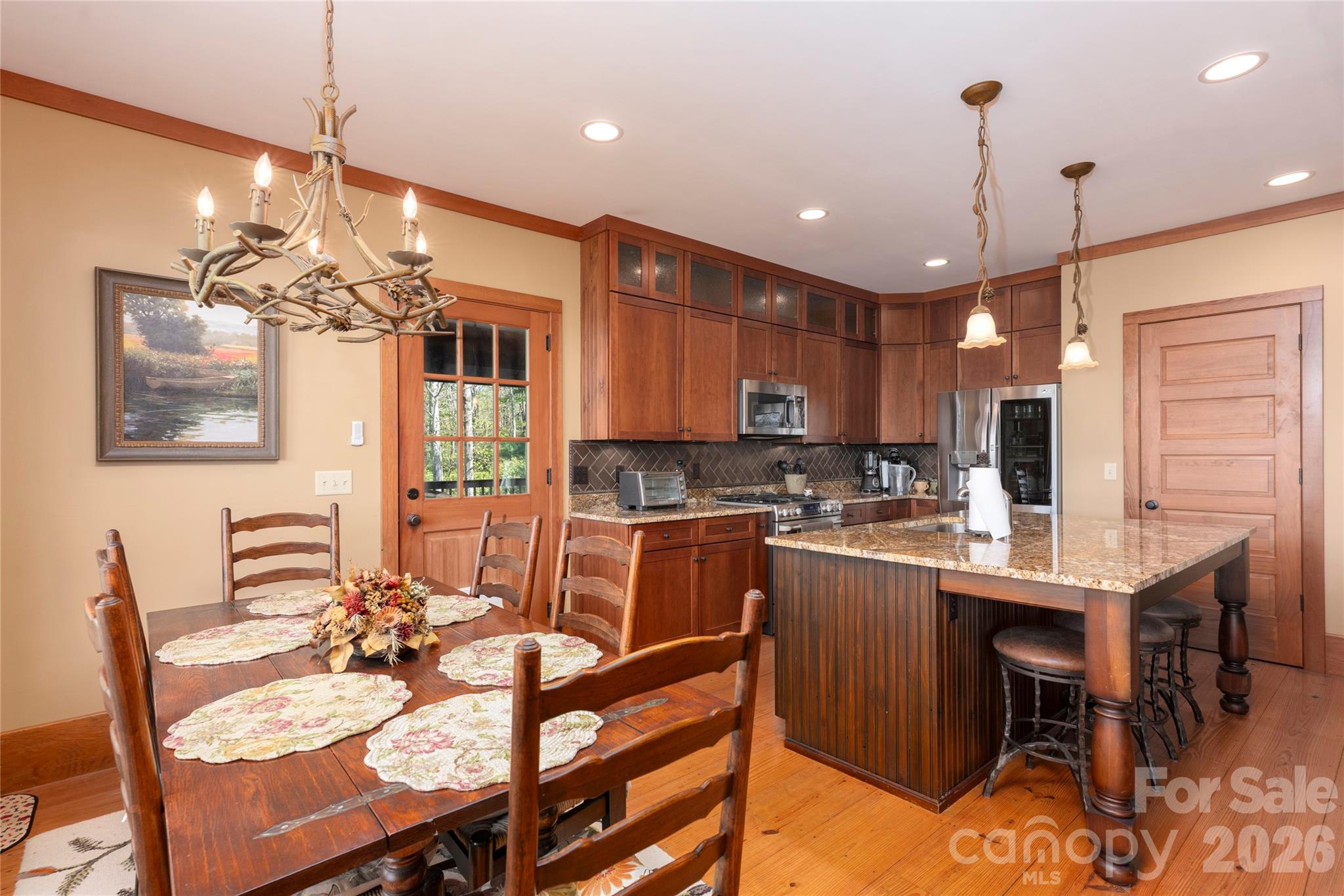 601 Hawk Mountain Road Lake Toxaway, NC 28747 - Photo 14 of 48 a kitchen with kitchen island a dining table chairs stainless steel appliances and cabinets