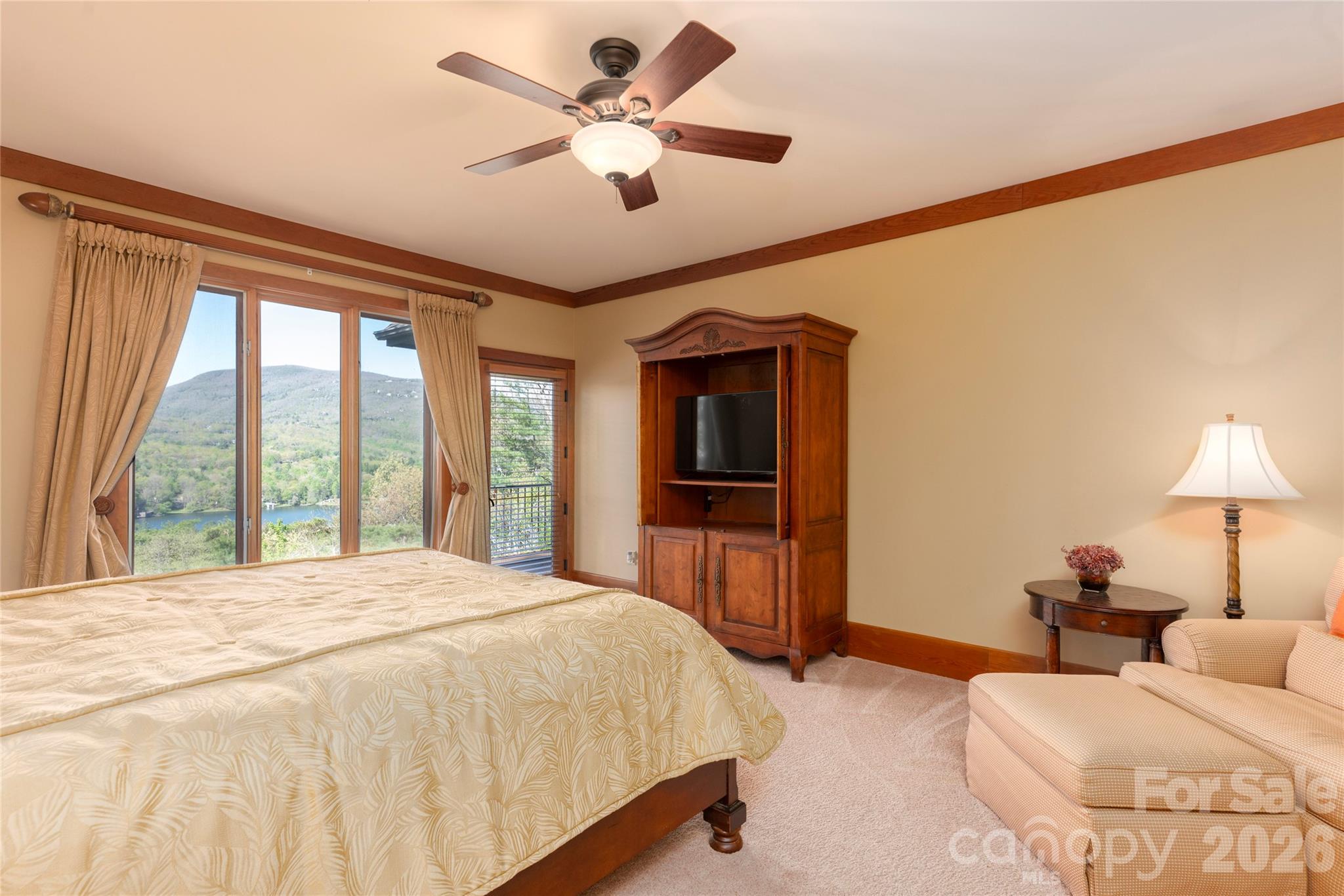 601 Hawk Mountain Road Lake Toxaway, NC 28747 - Photo 16 of 48 a spacious bedroom with a large bed and a chandelier