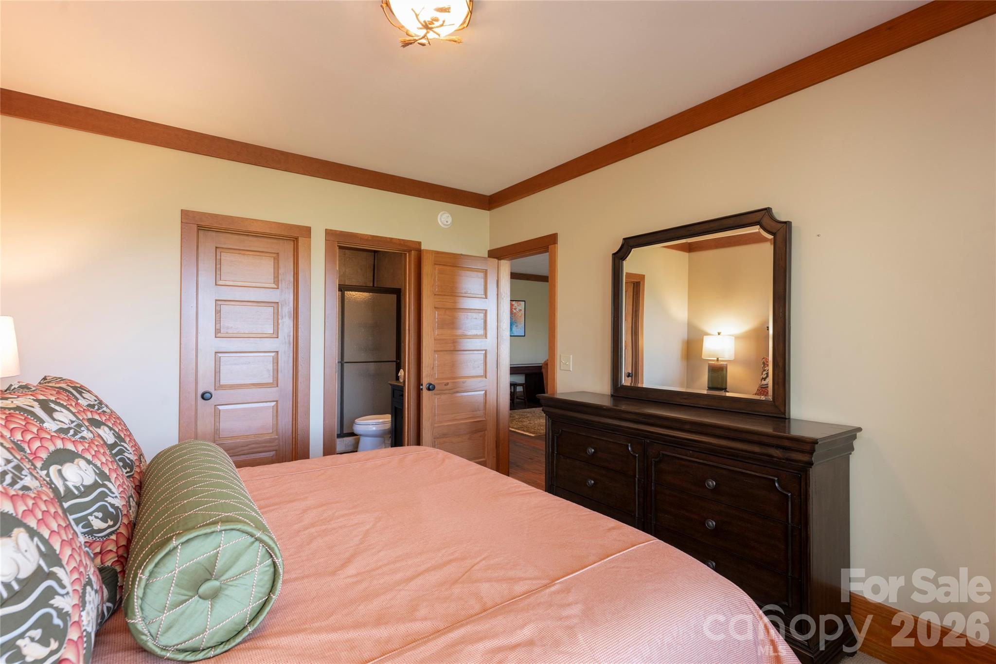 601 Hawk Mountain Road Lake Toxaway, NC 28747 - Photo 35 of 48 a bedroom with a bed and a mirror on dresser