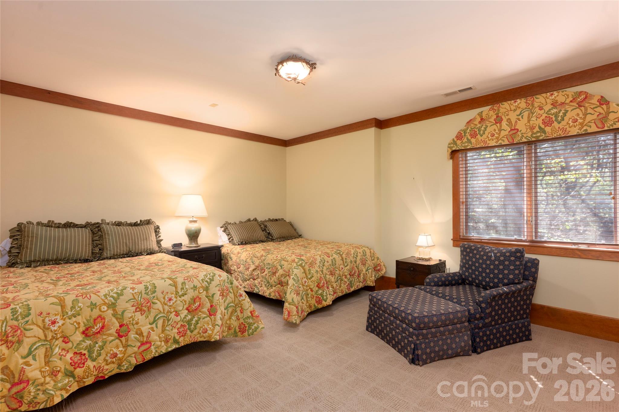 601 Hawk Mountain Road Lake Toxaway, NC 28747 - Photo 37 of 48 a bedroom with two beds and a large window with outer view