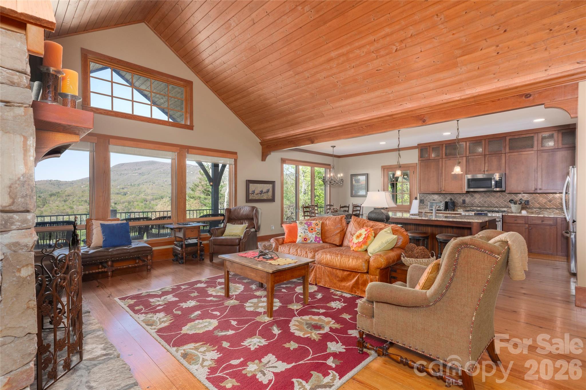 601 Hawk Mountain Road Lake Toxaway, NC 28747 - Photo 5 of 48 a living room with furniture a rug and a floor to ceiling window