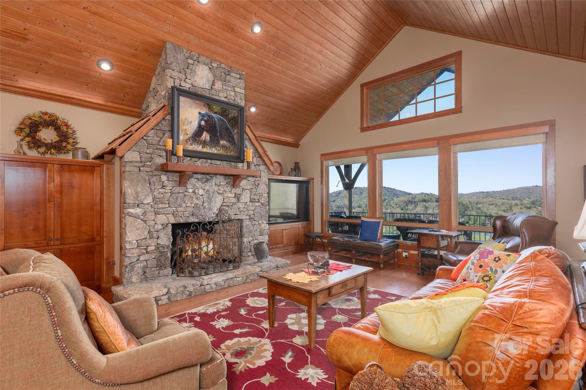 601 Hawk Mountain Road Lake Toxaway, NC 28747 - Photo 6 of 48 a living room with furniture a fireplace and a floor to ceiling window