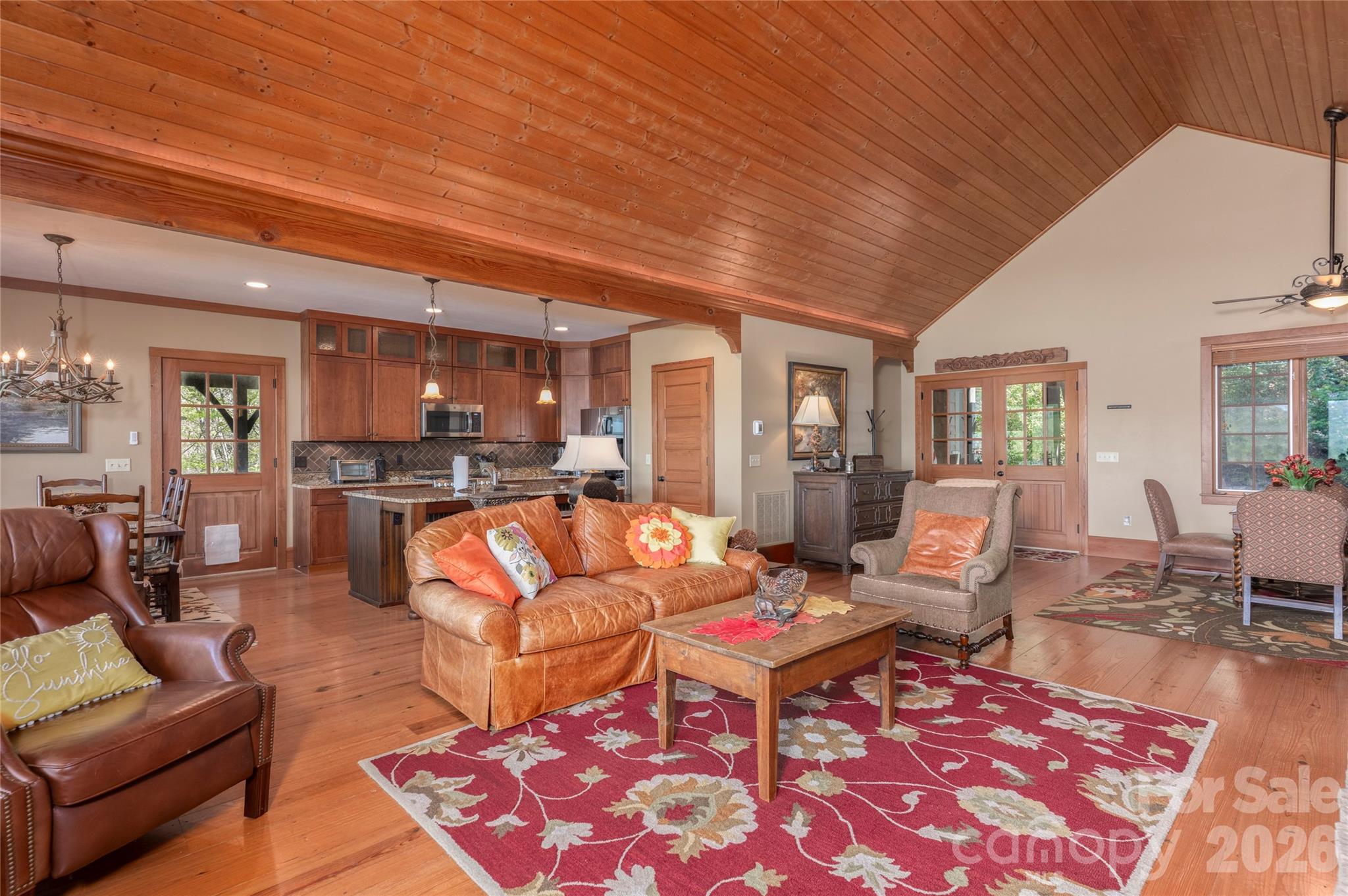 601 Hawk Mountain Road Lake Toxaway, NC 28747 - Photo 8 of 48 a living room with furniture a rug kitchen view and a large window
