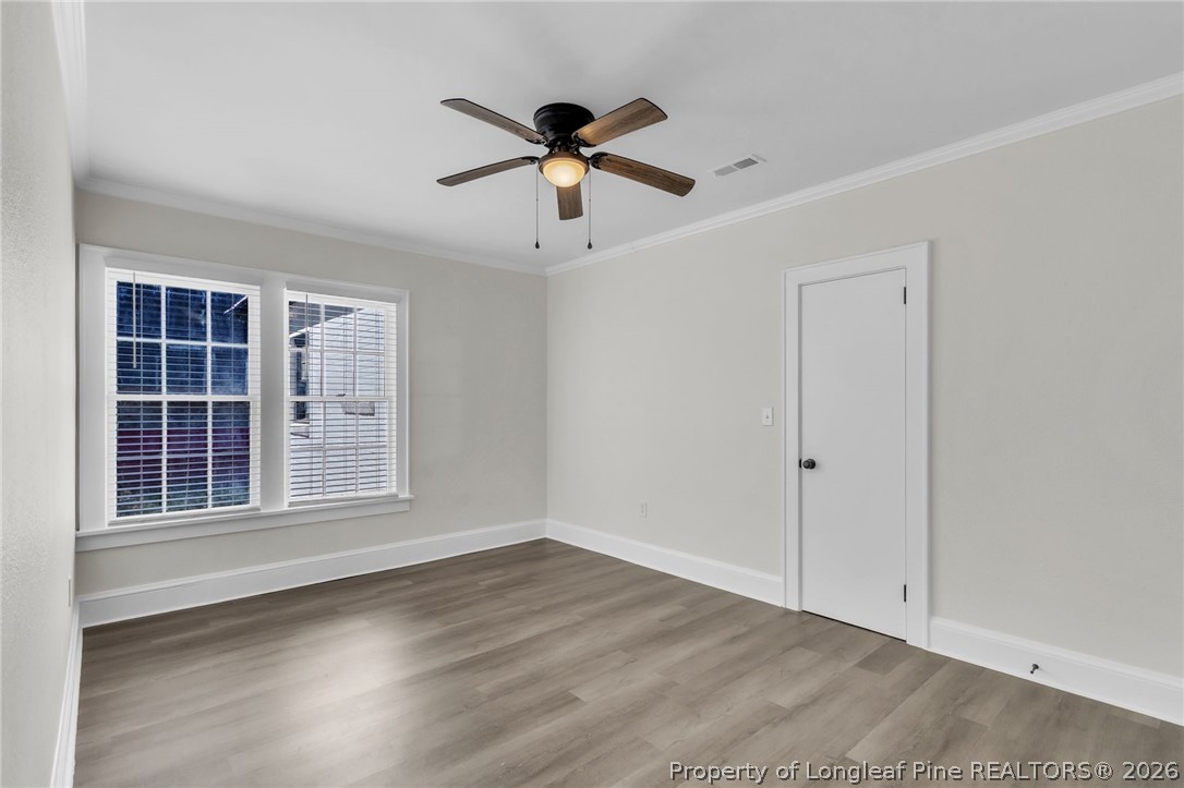 203 Trinity Street Fairmont, NC 28340 - Photo 18 of 34 a view of empty room with wooden floor and ceiling fan