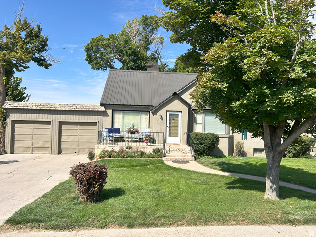 40 South State Street Scipio, UT 84656 - Photo 1 of 39 View of front facade with a front lawn, concrete driveway, a chimney, an attached garage, and a metal roof