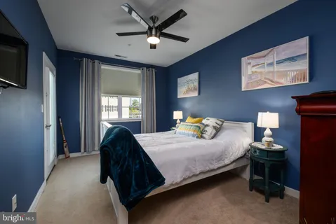a bedroom with a large bed and a chandelier