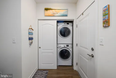 a kitchen with stainless steel appliances kitchen island granite countertop a stove a refrigerator a sink a dining table and chairs