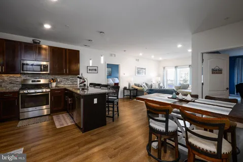 a kitchen with a sink stove microwave and refrigerator