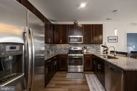 a kitchen with a sink a counter space and cabinets