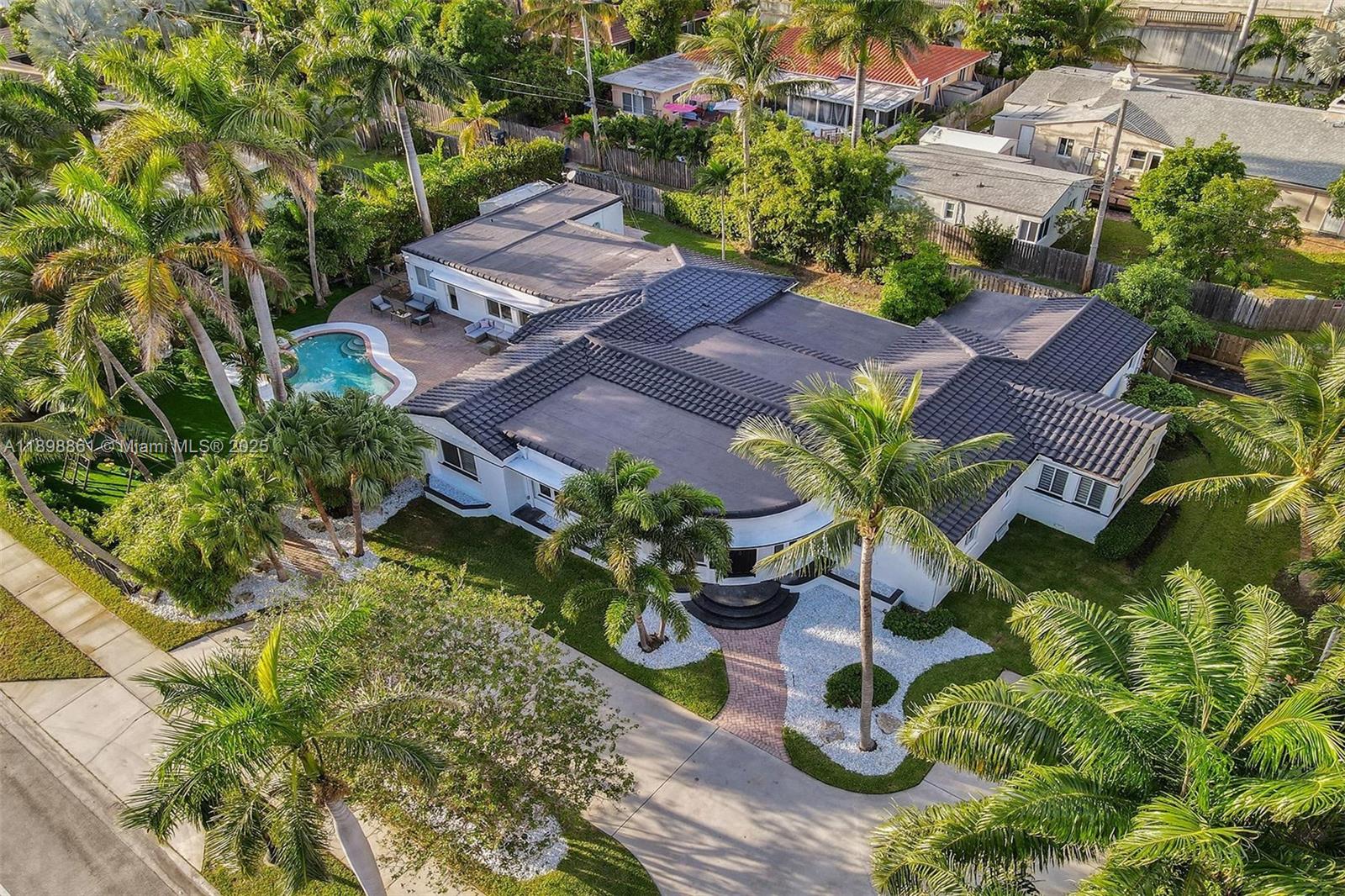 725 Harrison Street Hollywood, FL 33019 - Photo 1 of 91 an aerial view of a house with garden space and lake view