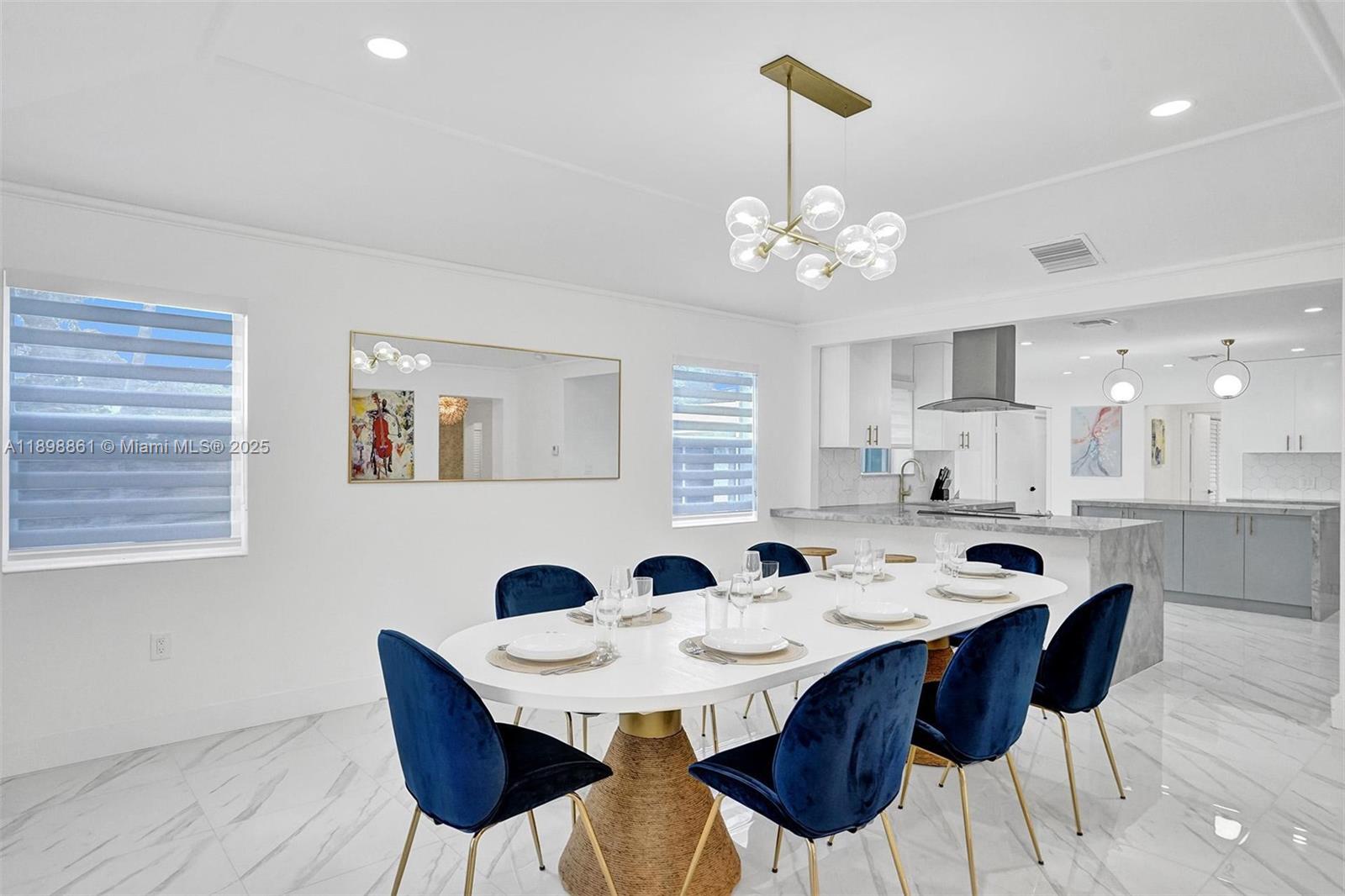 725 Harrison Street Hollywood, FL 33019 - Photo 22 of 91 a view of a dining room with furniture and chandelier