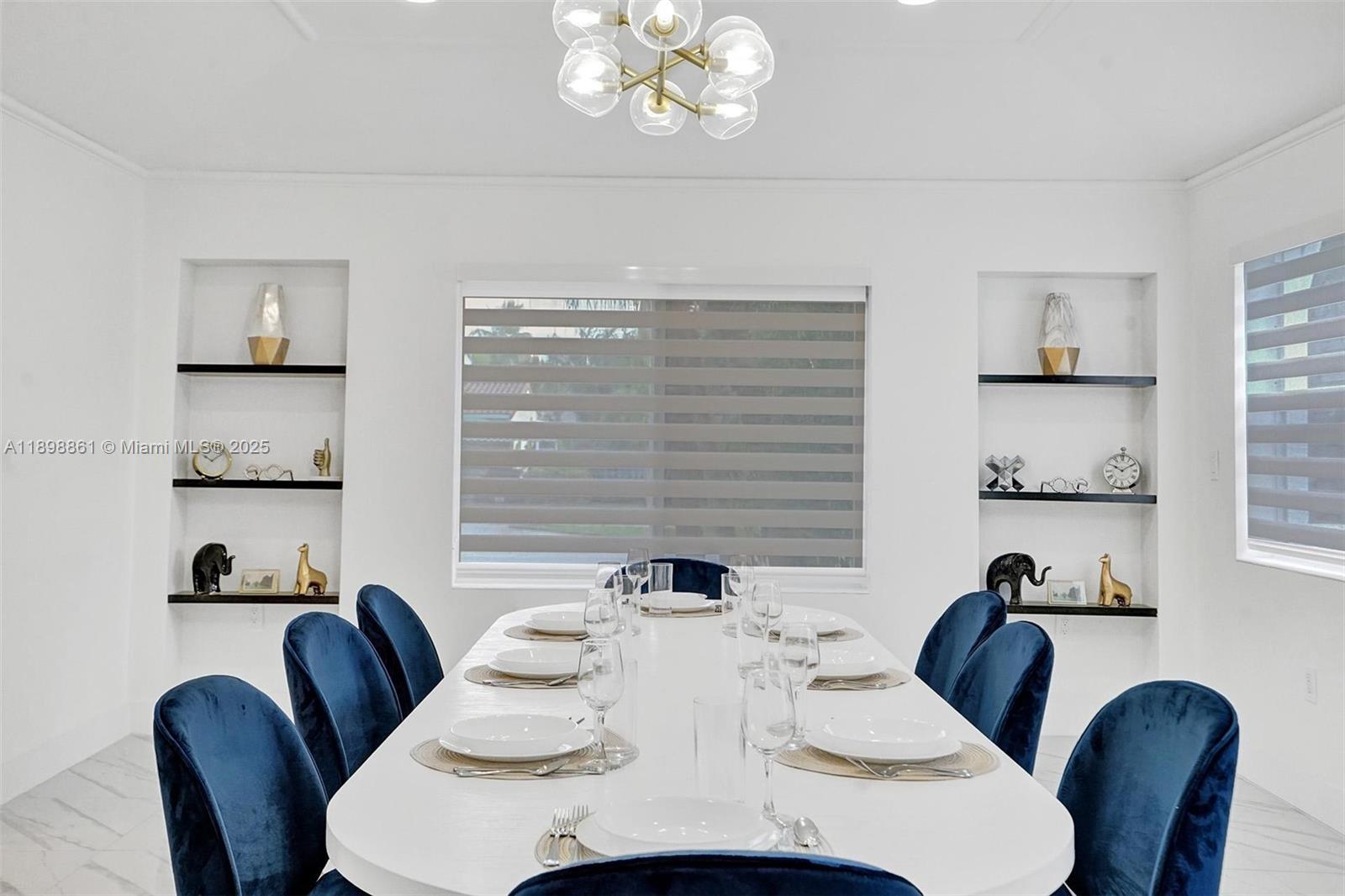 725 Harrison Street Hollywood, FL 33019 - Photo 23 of 91 a view of a dining room with furniture and chandelier