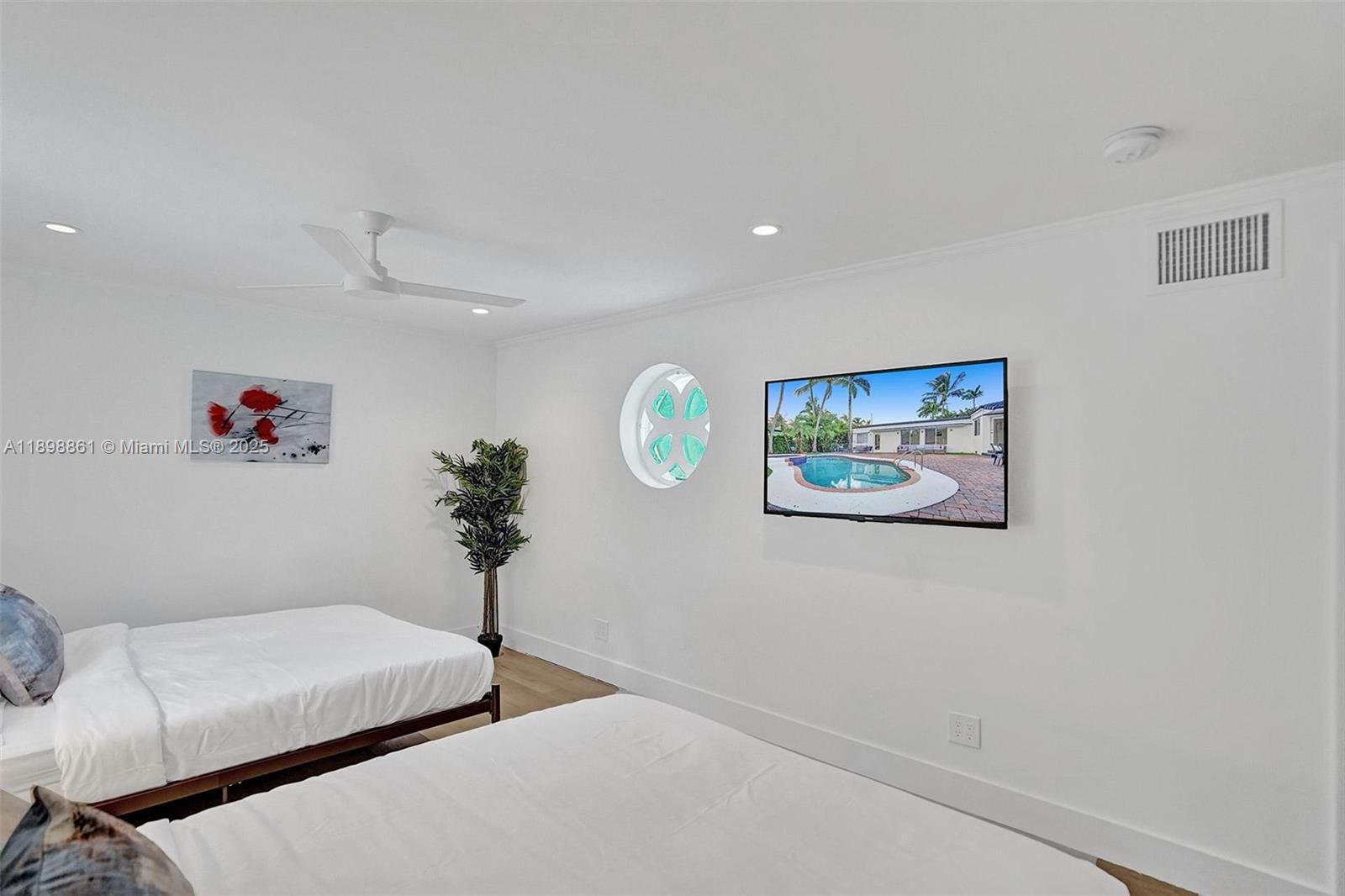 725 Harrison Street Hollywood, FL 33019 - Photo 32 of 91 a bedroom with a bed and a potted plant