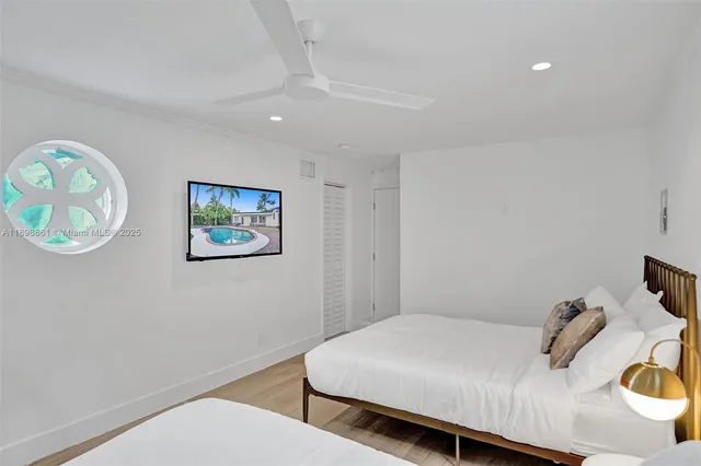 a bedroom with a bed and a painting on the wall