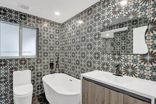 a spacious bedroom with a bed and a chair