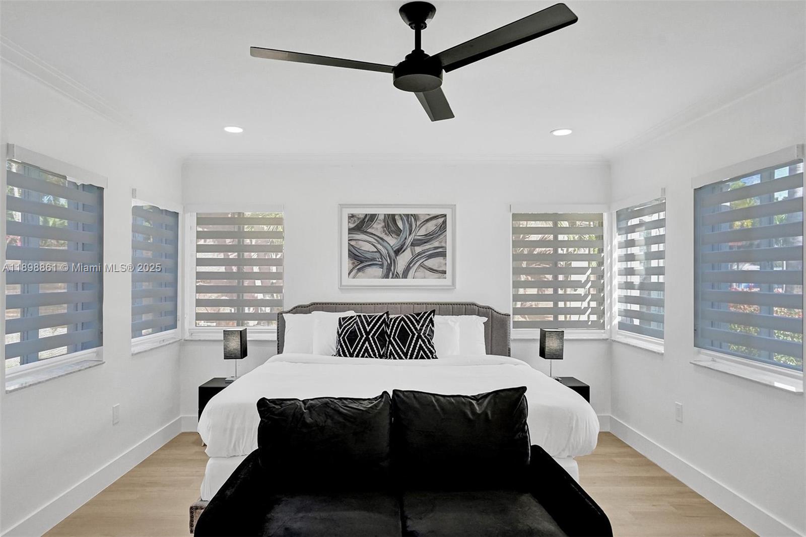 725 Harrison Street Hollywood, FL 33019 - Photo 38 of 91 a bedroom with a bed and wooden floor