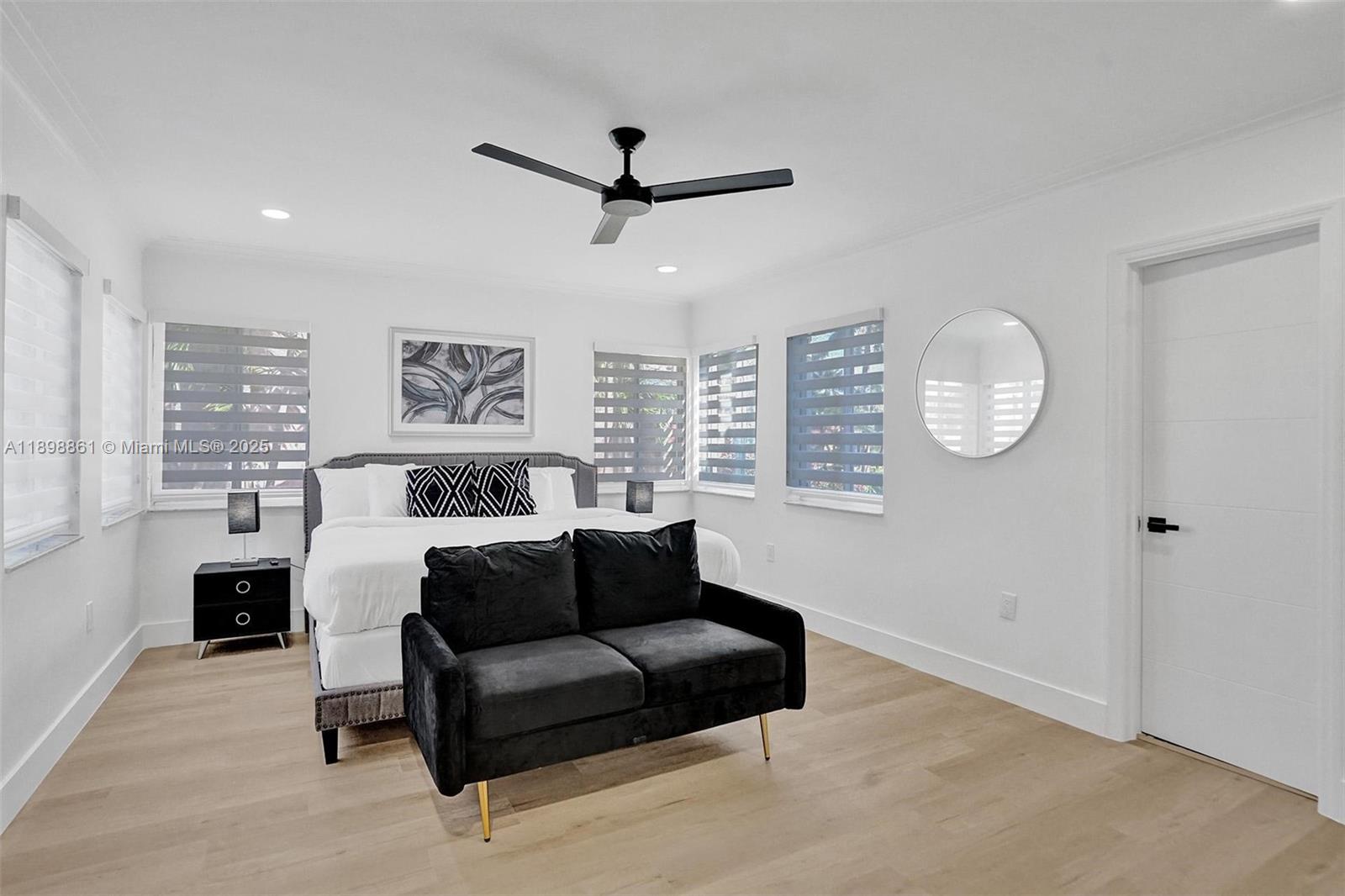 725 Harrison Street Hollywood, FL 33019 - Photo 40 of 91 a living room with furniture a large window and a ceiling fan