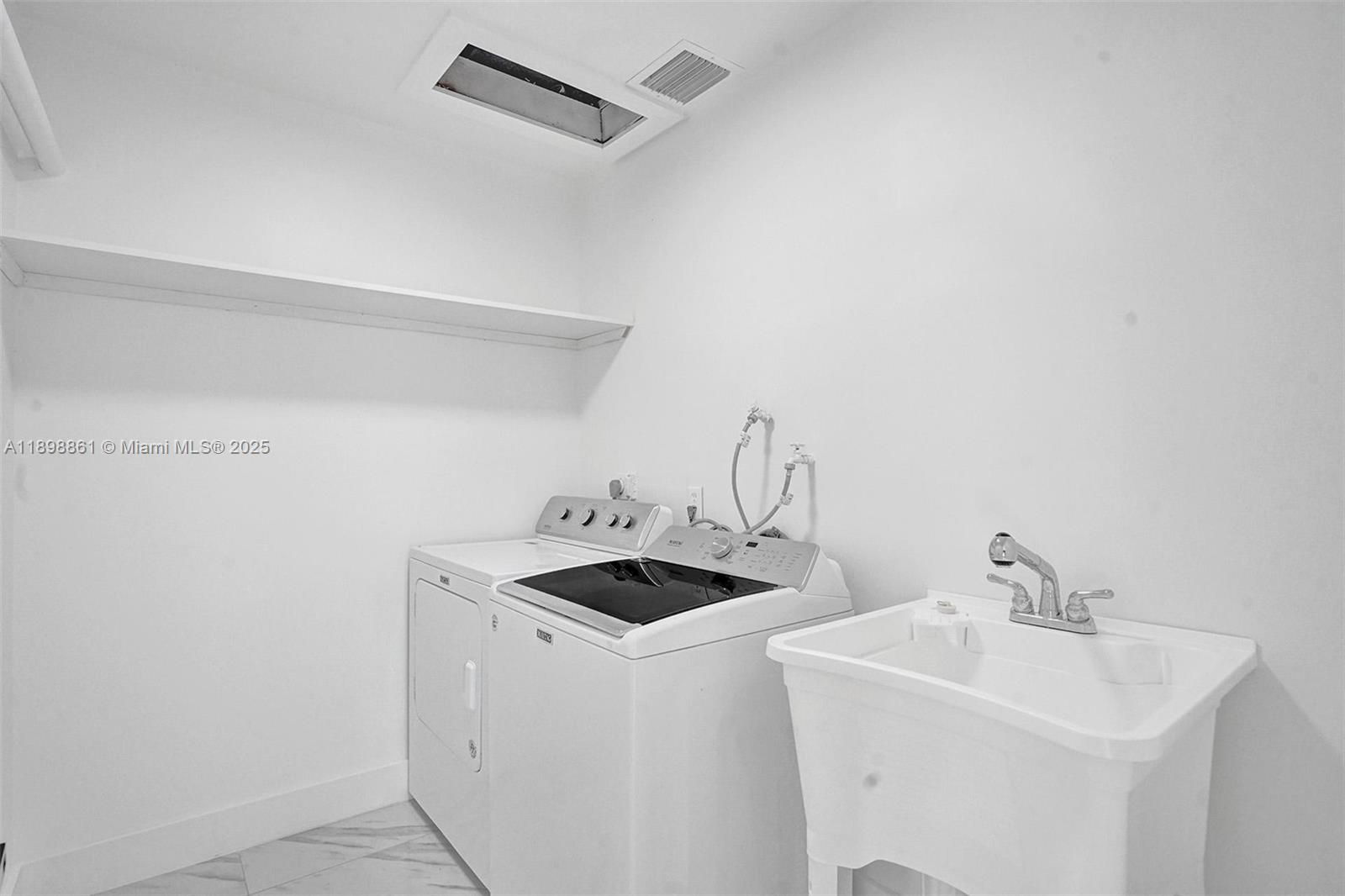 725 Harrison Street Hollywood, FL 33019 - Photo 46 of 91 a kitchen with a sink and cabinets