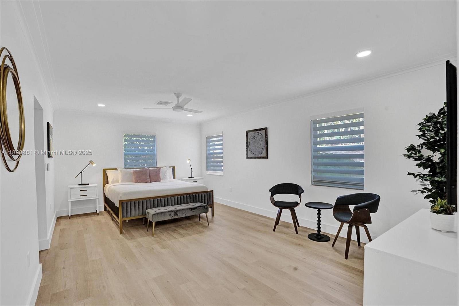 725 Harrison Street Hollywood, FL 33019 - Photo 59 of 91 a spacious bedroom with a bed and a chair