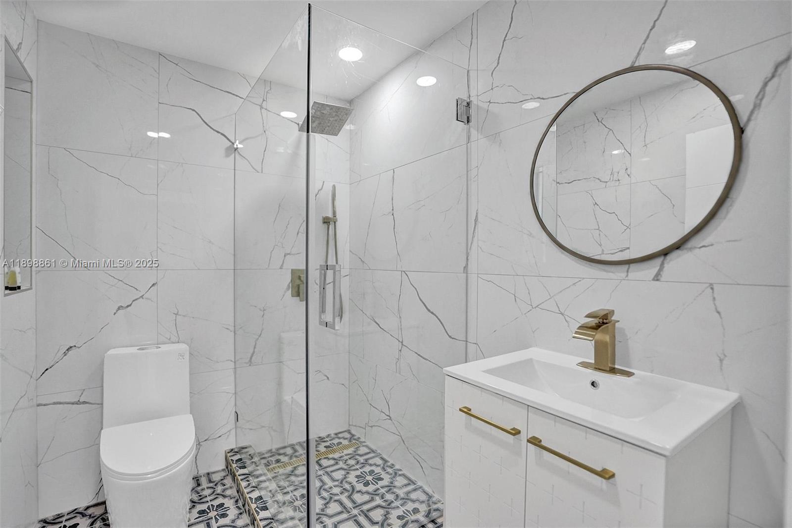 725 Harrison Street Hollywood, FL 33019 - Photo 64 of 91 a bathroom with a sink toilet and a mirror